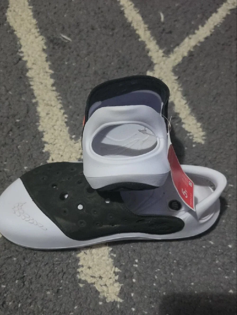 Nike Kids Black and White Slip-On Sandals with Perforated Upper